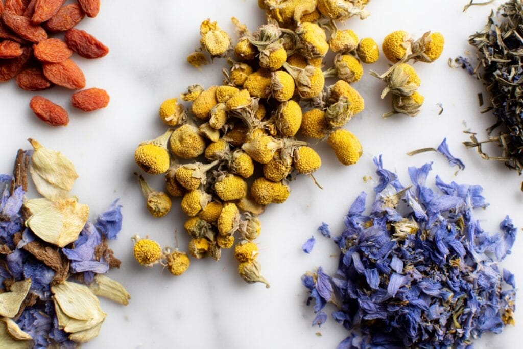 Are Goji Berries Safe for You? 4 Potential Side Effects and Drug Interactions You Should Know 2 2025 08 Goji berries chamomile blue flower on white table